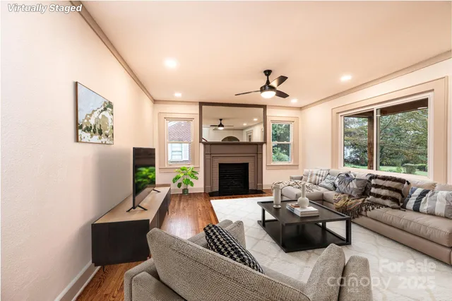 a living room with furniture large window and fireplace