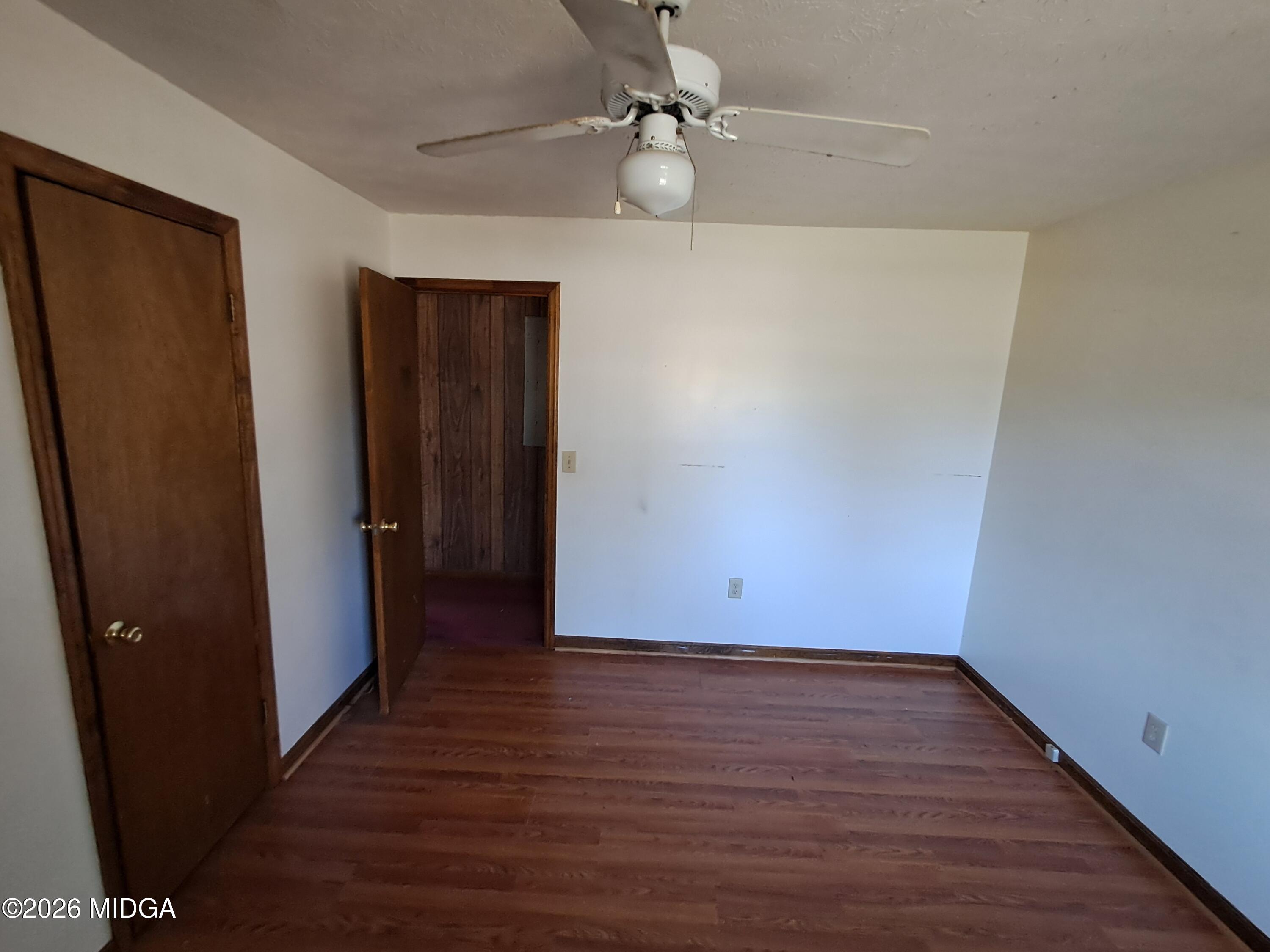 110 Irwinton Road Toomsboro, GA 31090 - Photo 10 of 17 wooden floor in an empty room