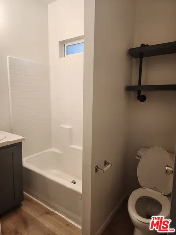 a bathroom with a toilet and a bathtub