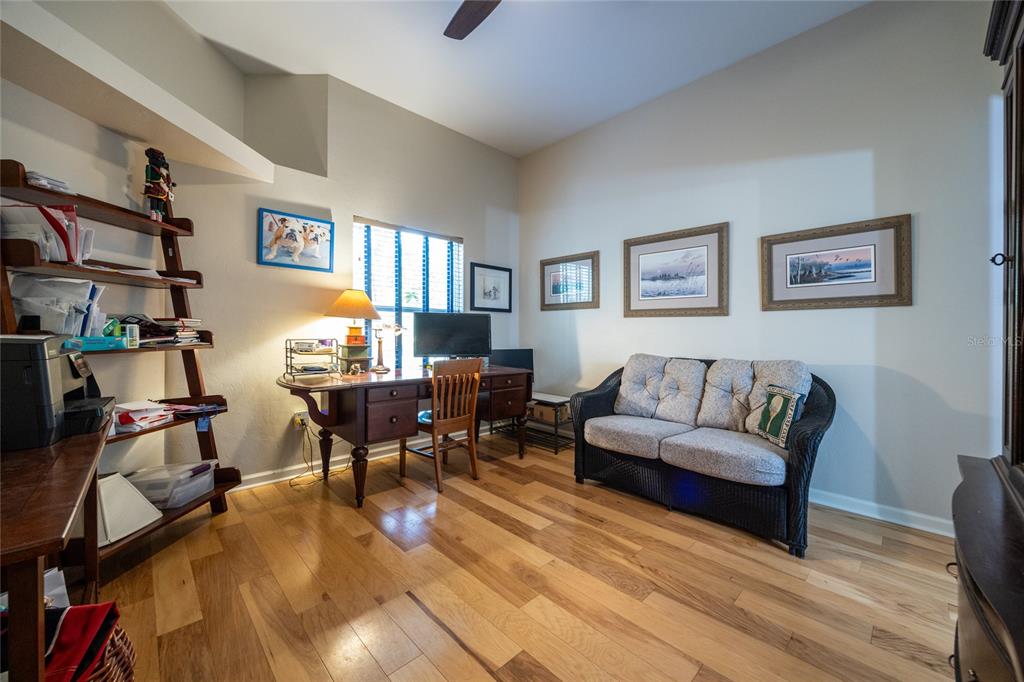 11616 Southwest 6th Lane Gainesville, FL 32607 - Photo 34 of 67 a living room with furniture and a flat screen tv with wooden floor