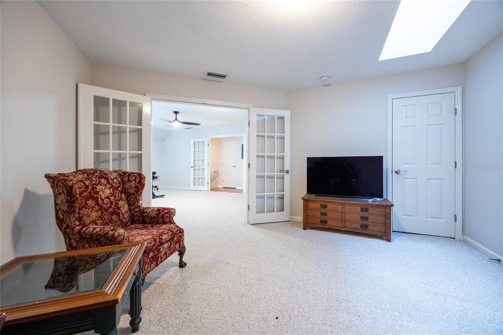 11616 Southwest 6th Lane Gainesville, FL 32607 - Photo 48 of 67 a living room with furniture and a flat screen tv