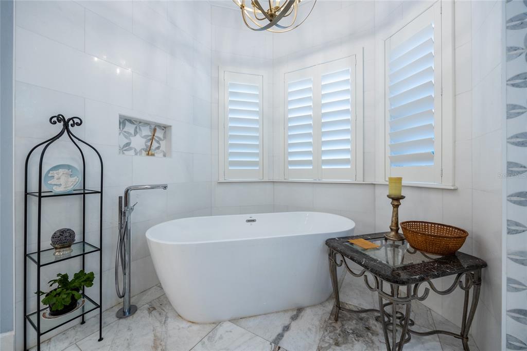 11616 Southwest 6th Lane Gainesville, FL 32607 - Photo 60 of 67 a white bath tub sitting in a bathroom next to a window