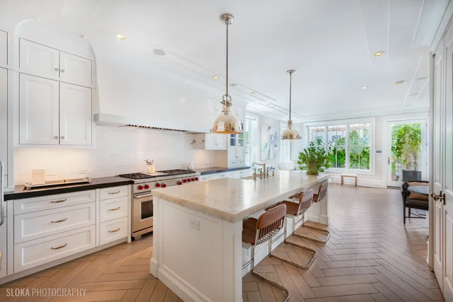 a kitchen with granite countertop white cabinets and sink