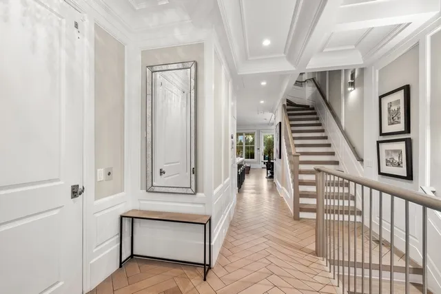 a view of a balcony with chairs and a potted plant