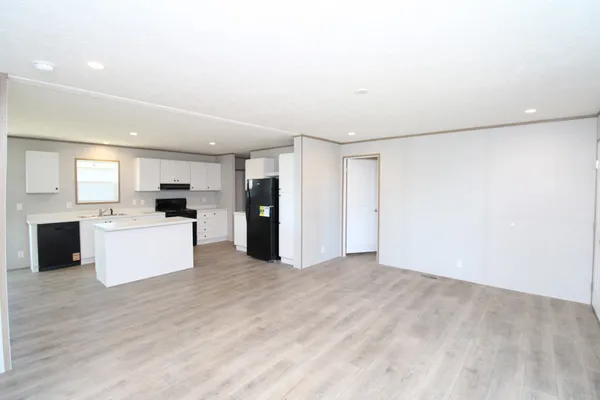 a view of kitchen with cabinets and refrigerator