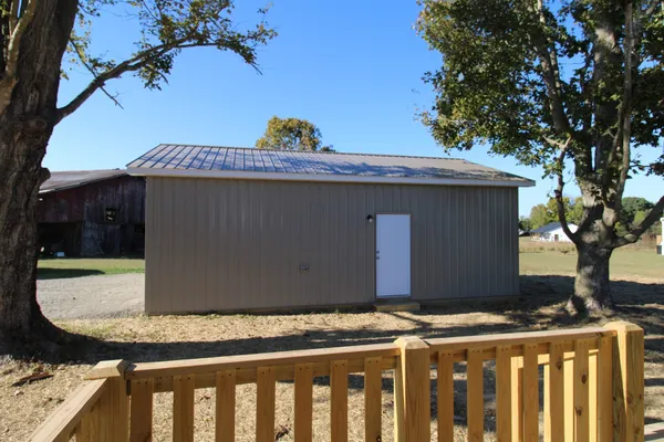 a view of a room with racks on the wall and a large window