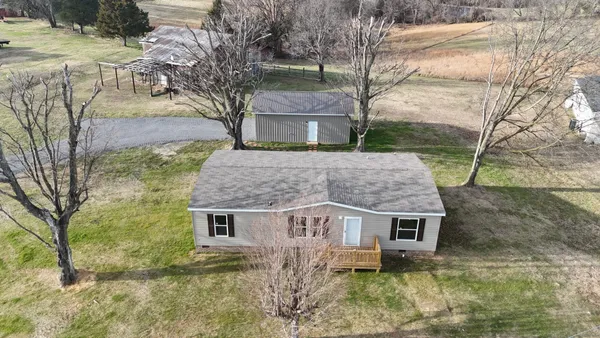 a view of a house with a yard covered in snow