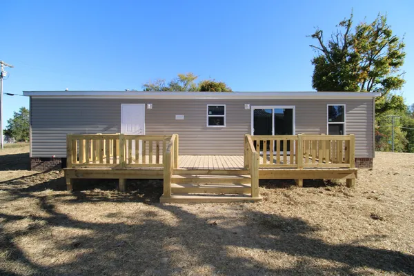 a view of kitchen with kitchen island a refrigerator sink and cabinets