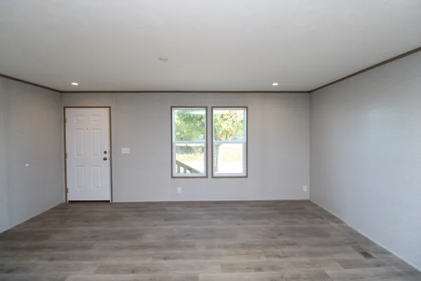 a view of kitchen with refrigerator and cabinets