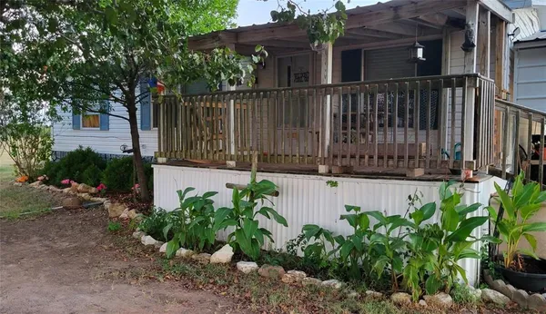a view of a house with wooden fence