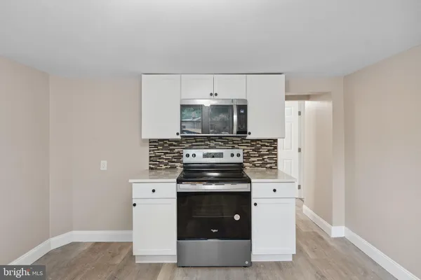 a kitchen with a stove and a microwave