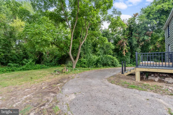 a view of a yard with wooden fence