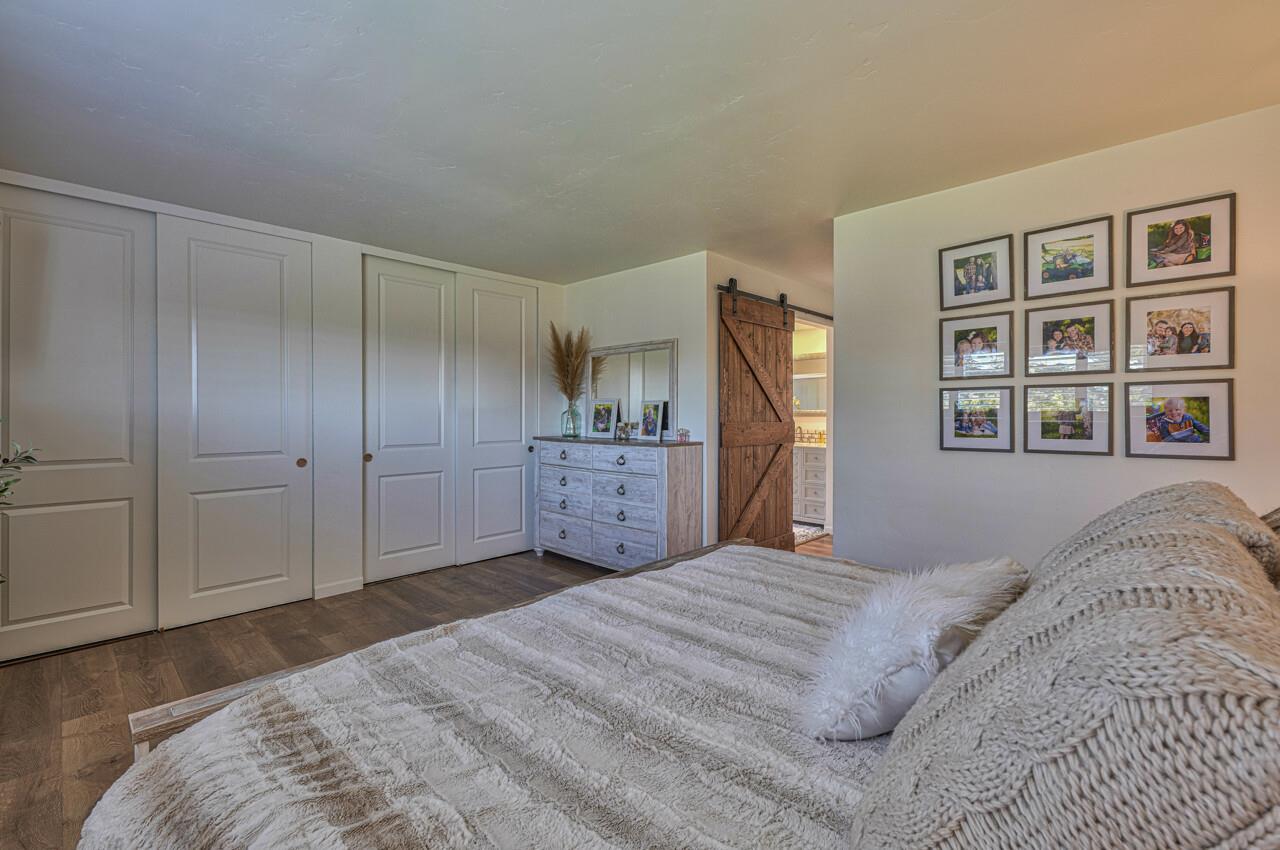 9859 Brookgrass Place Prunedale, CA 93907 - Photo 18 of 39 a bedroom with a large bed and a closet
