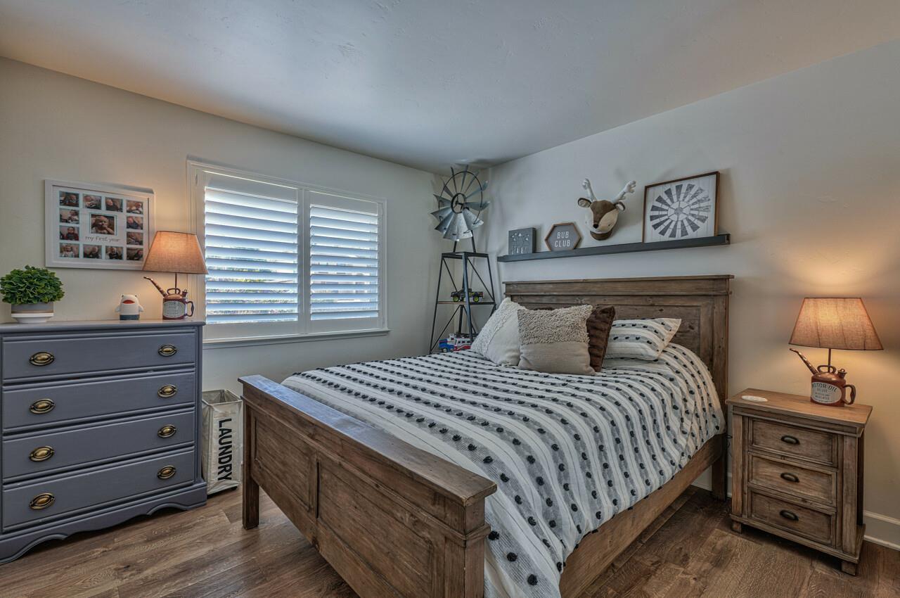 9859 Brookgrass Place Prunedale, CA 93907 - Photo 21 of 39 a bedroom with a bed and a dresser in it