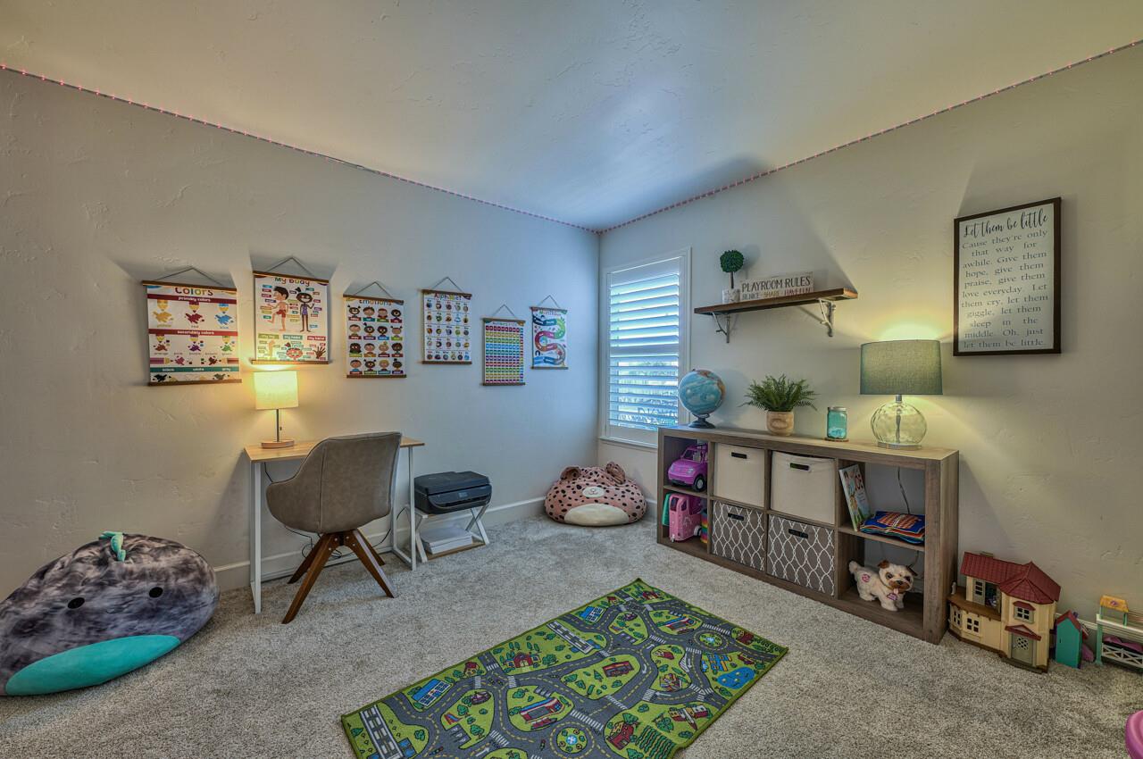 9859 Brookgrass Place Prunedale, CA 93907 - Photo 25 of 39 a room with furniture a rug and gym equipment