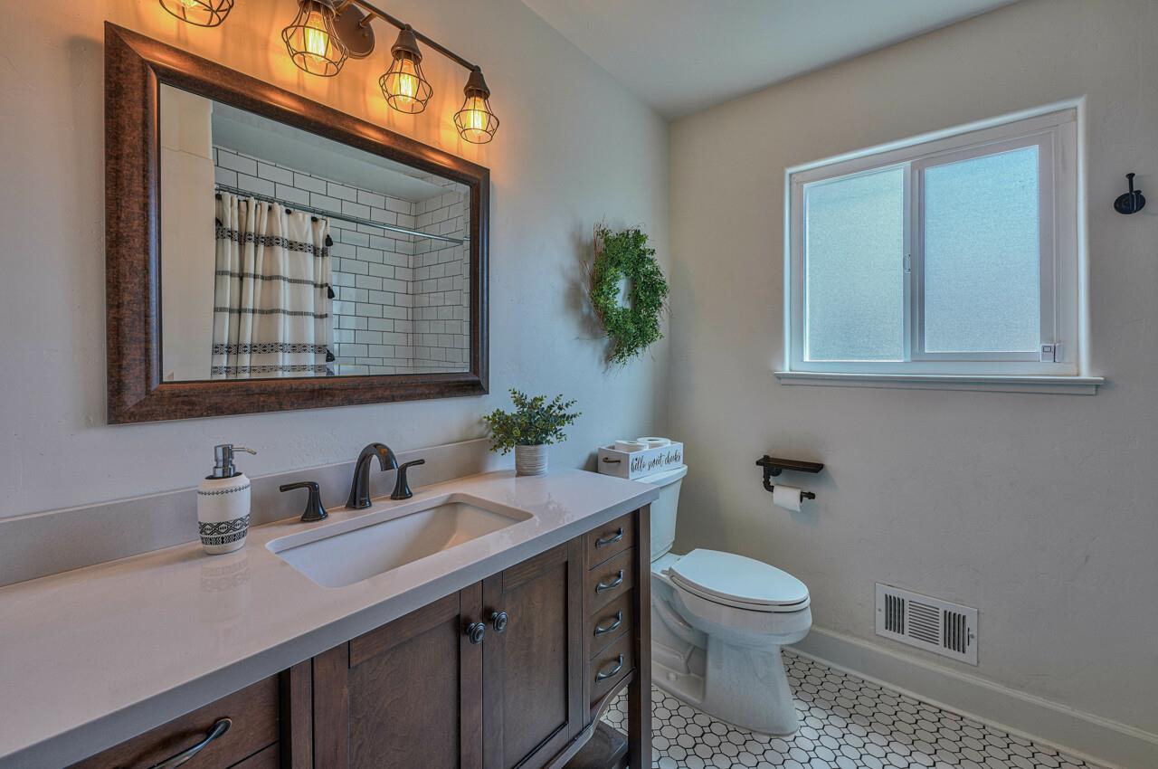9859 Brookgrass Place Prunedale, CA 93907 - Photo 27 of 39 a bathroom with a toilet a sink and mirror