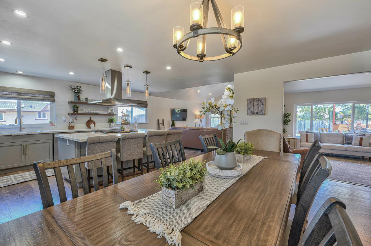 9859 Brookgrass Place Prunedale, CA 93907 - Photo 8 of 39 a view of a dining room and livingroom with furniture a rug a kitchen view and a chandelier