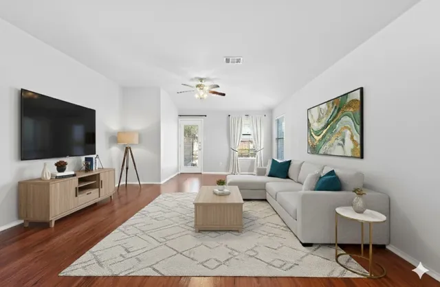 a living room with furniture and a flat screen tv