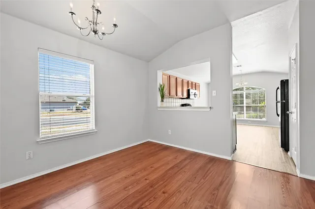 a kitchen with stainless steel appliances a sink dishwasher a stove a microwave oven with cabinets and wooden floor