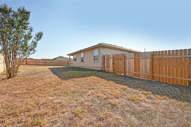 a view of swimming pool with outdoor seating and a garden