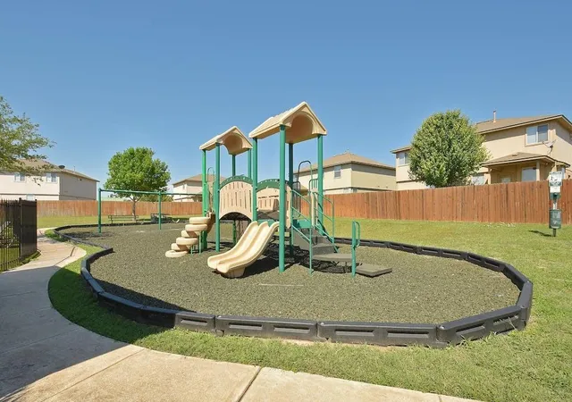 a view of a house with a yard and table and chairs