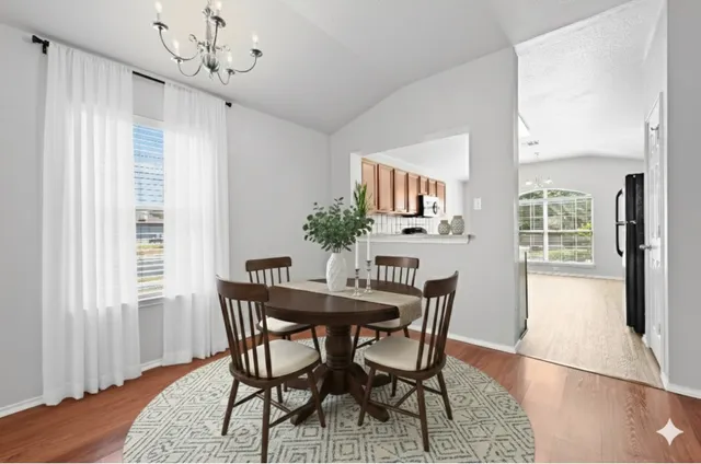 a view of a dining room with furniture window and wooden floor