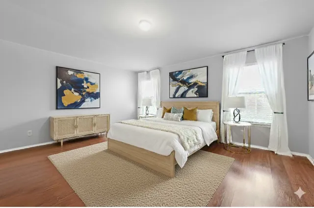 a bedroom with a bed and a painting on the wall