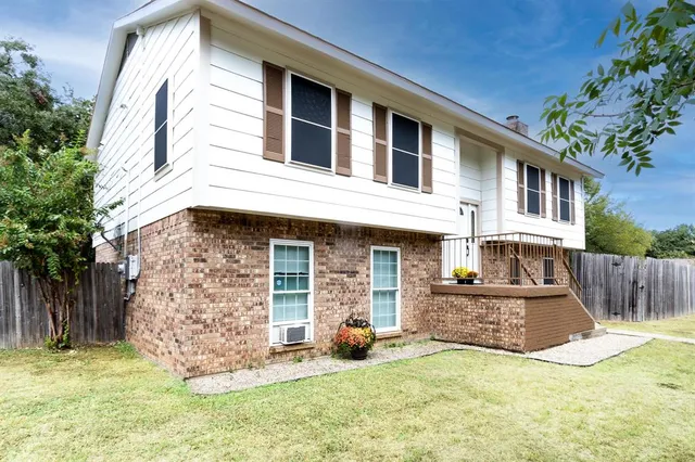 a view of a house with a yard and sitting area