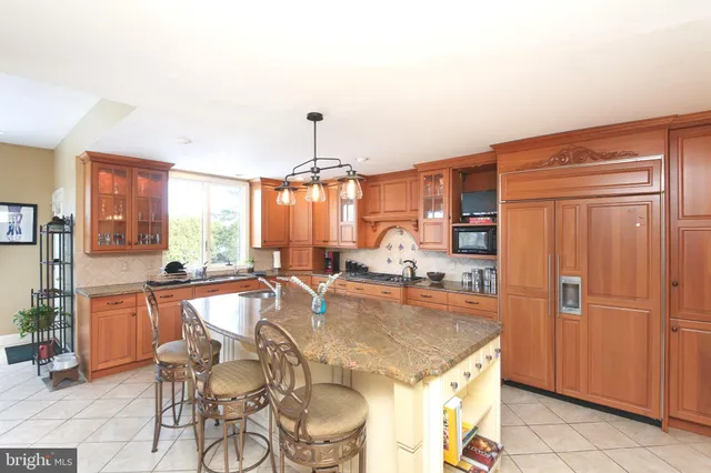 a kitchen with granite countertop kitchen island stainless steel appliances a table and chairs