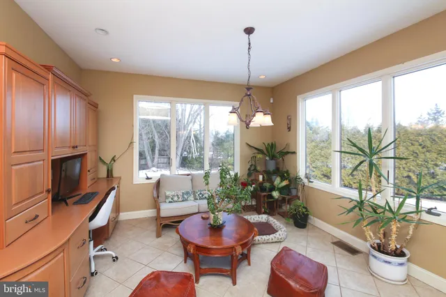 a living room with fireplace furniture and a large window