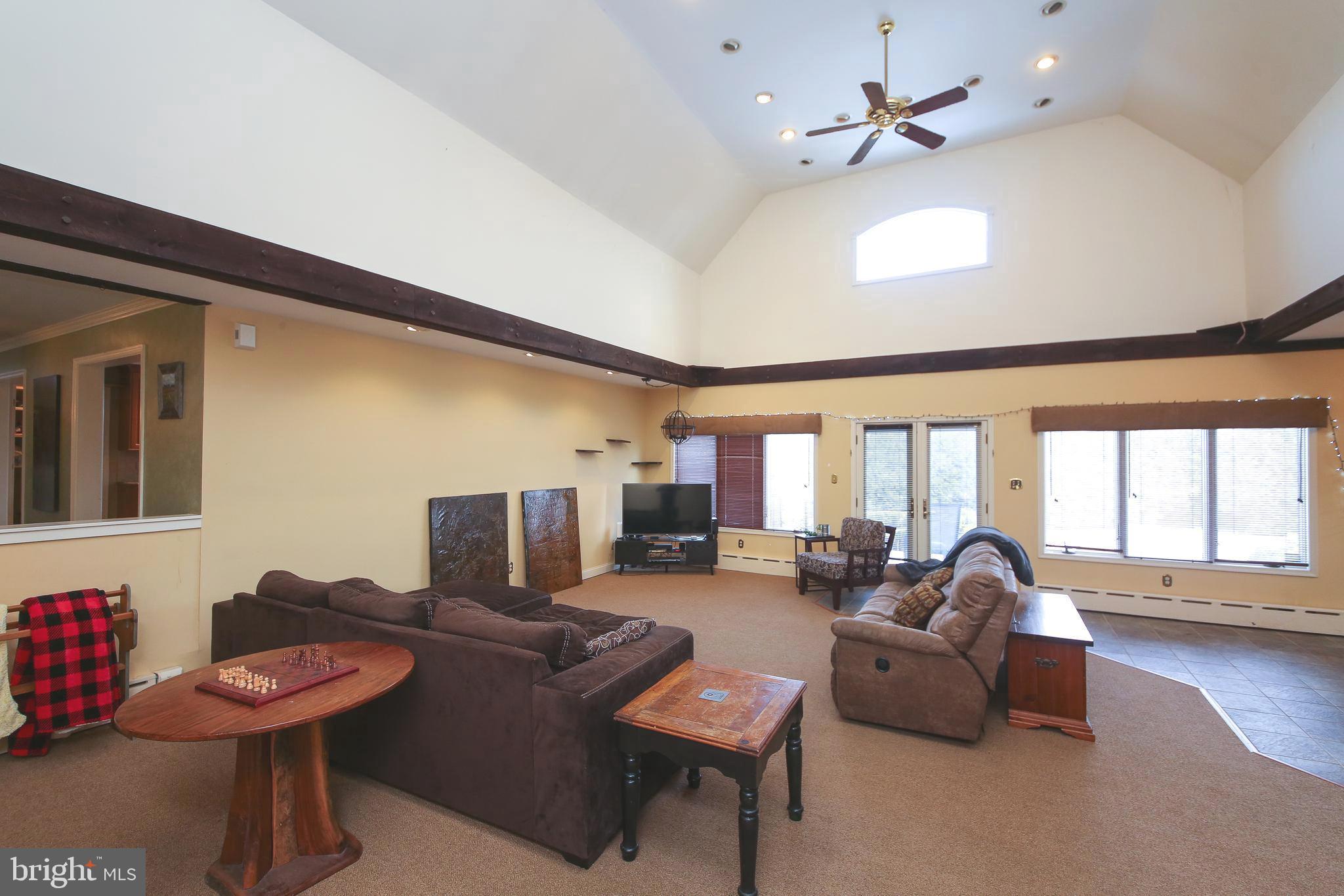 531 Hunsicker Road Telford, PA 18969 - Photo 17 of 32 a living room with furniture a flat screen tv and a large window