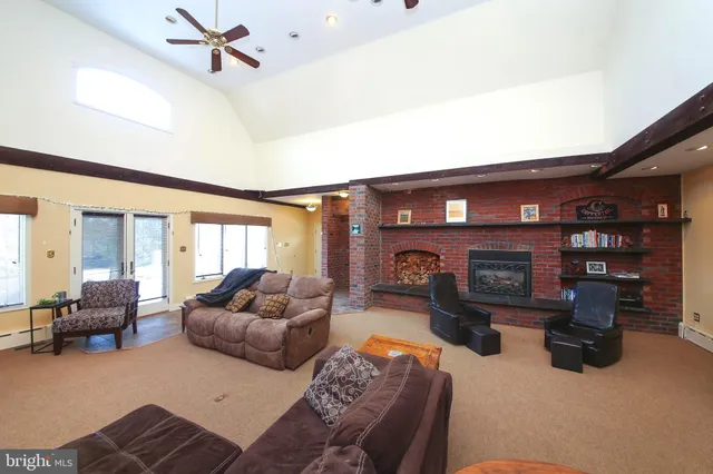 a living room with furniture and a fireplace