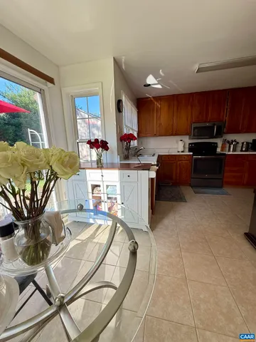 a kitchen with stainless steel appliances kitchen island granite countertop a sink and cabinets