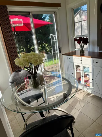 a view of a dining room with furniture and floor to ceiling window