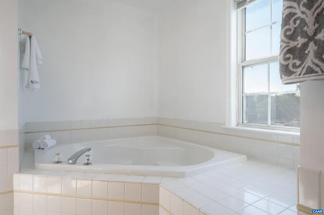 a white bath tub sitting next to a window