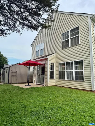a view of a house with a backyard