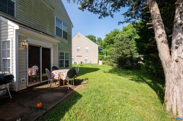 a swimming pool with outdoor seating yard and green space