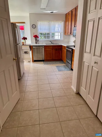 a kitchen with stainless steel appliances a stove a sink and a refrigerator