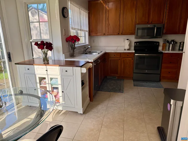 a kitchen with stainless steel appliances granite countertop a stove and a refrigerator