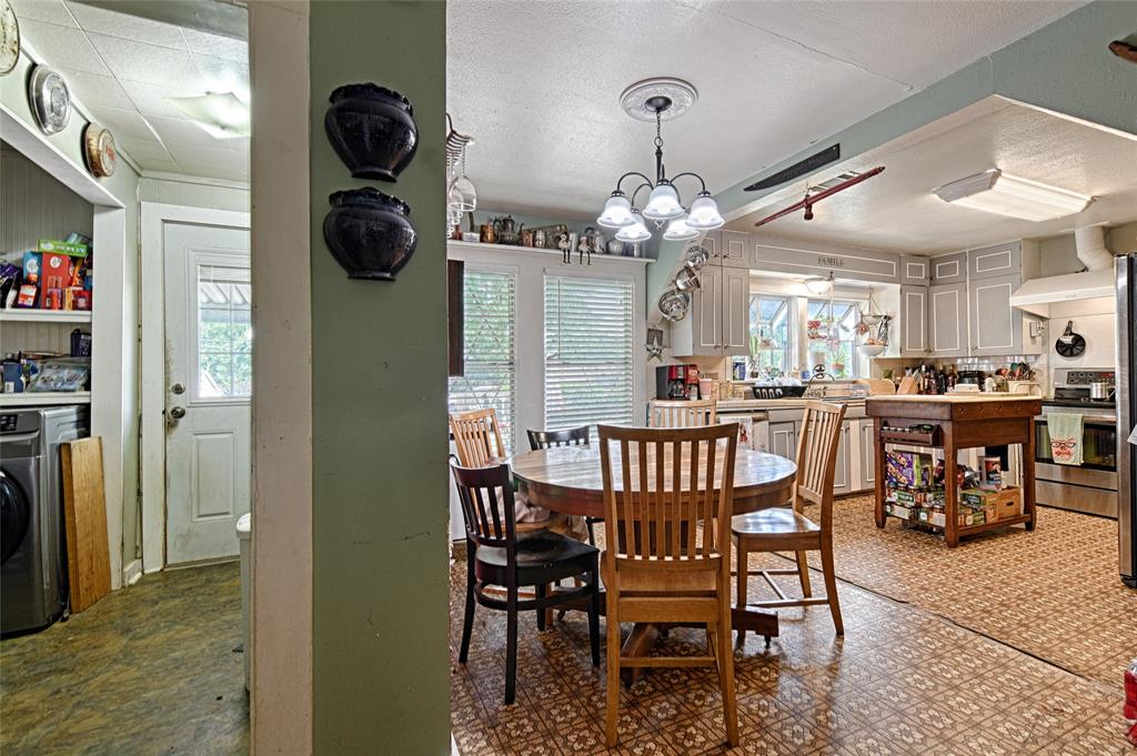205 West Stark Road Seagoville, TX 75159 - Photo 12 of 39 a view of a dining room and livingroom with furniture wooden floor a chandelier