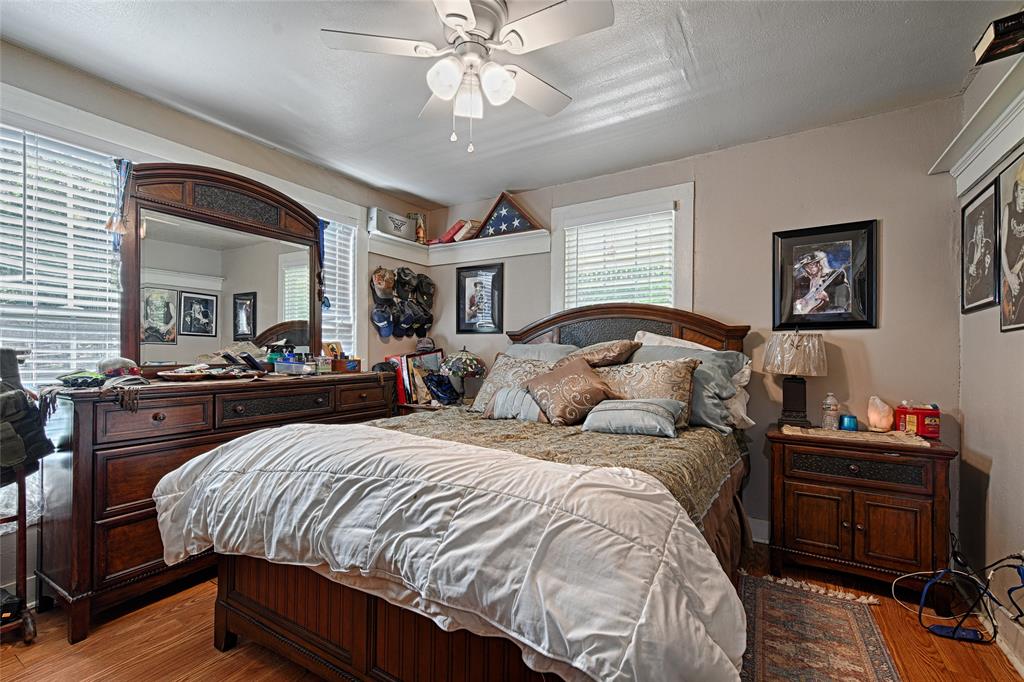 205 West Stark Road Seagoville, TX 75159 - Photo 13 of 39 a bedroom with bed and a chandelier