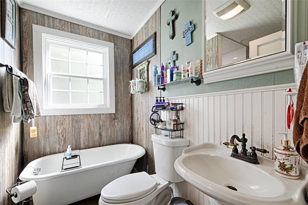 205 West Stark Road Seagoville, TX 75159 - Photo 16 of 39 a bathroom with a toilet sink and mirror