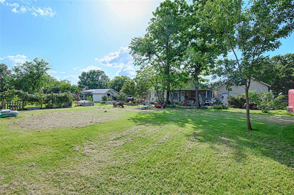 205 West Stark Road Seagoville, TX 75159 - Photo 25 of 39 a view of a house with backyard and a tree