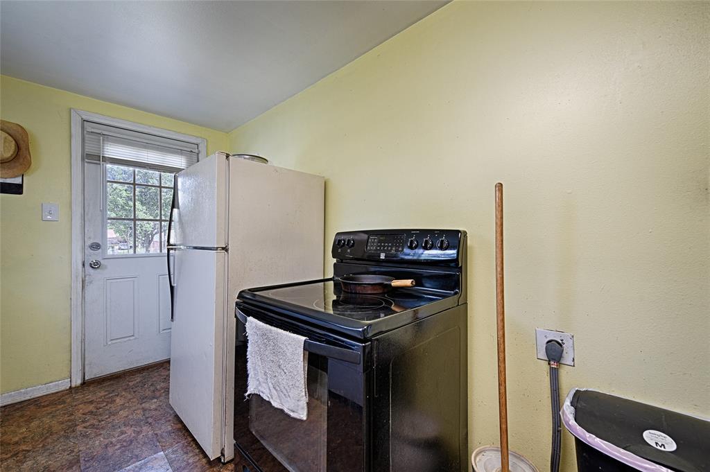 205 West Stark Road Seagoville, TX 75159 - Photo 32 of 39 a kitchen with a stove and a refrigerator