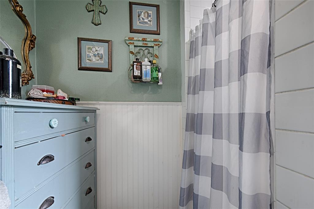205 West Stark Road Seagoville, TX 75159 - Photo 33 of 39 a view of a bathroom with shower and wall painting on the wall