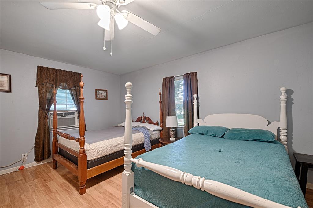 205 West Stark Road Seagoville, TX 75159 - Photo 34 of 39 a bedroom with two beds and a chandelier