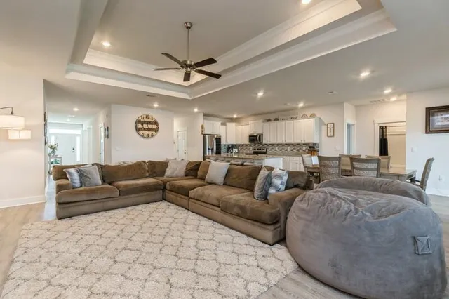 a living room with furniture and a ceiling fan