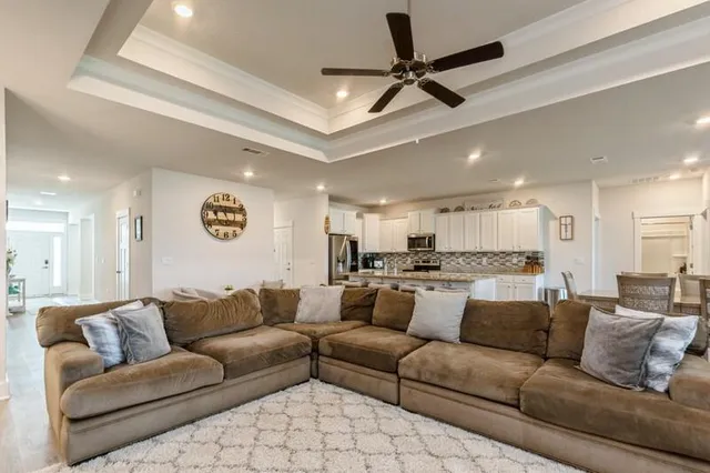 a view of a living room a rug and a ceiling fan