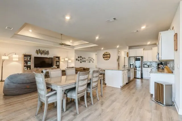 a view of a dining room with furniture and wooden floor