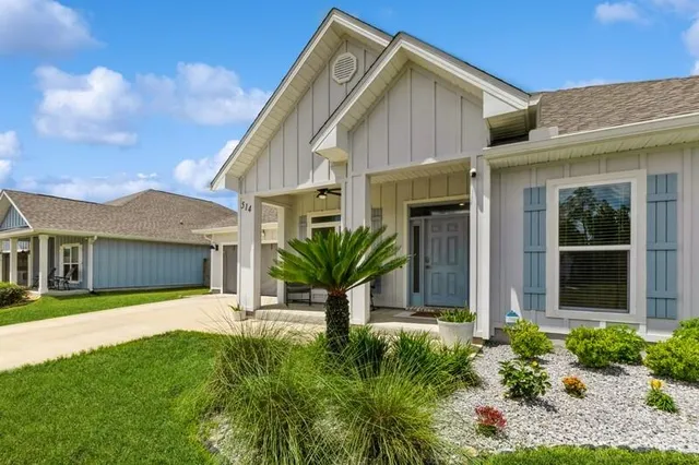 a view of a house with a yard and plants